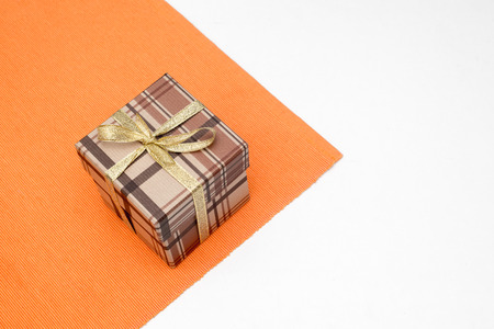 brown gift box with bow on white backgroundの写真素材