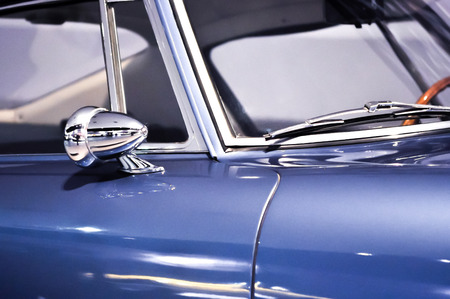 rear view mirror and car wipers on blue oldtimerの写真素材