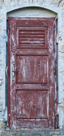 an old brown yellow ragged shabby wooden doorの写真素材