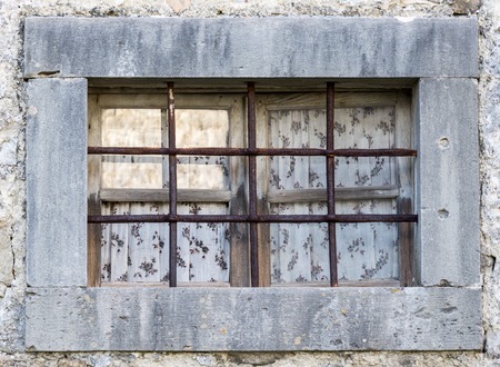an old window with the metal barsの写真素材