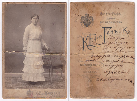 Tsarskoye Selo, Russia, August 24, 1916. An old photograph of a postcard (without restoration), which depicts a woman in an antique outfit. On the reverse side with a personalized printed text and coat of arms: "Photographer of His Majesty's Courtyard". Hのeditorial素材