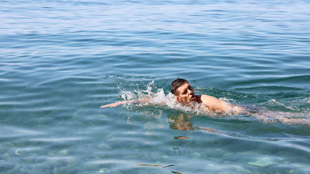 Swimmer swims on the surface of the water, with effort, with copy spaceの写真素材