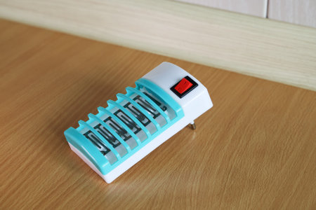 Electric fumigator to protect against mosquitoes is on floor in turn off position