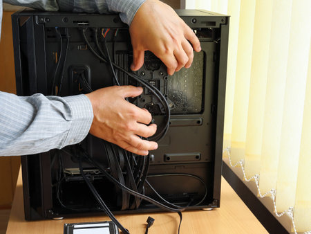 Assembling new computer, setting parts and laying wires in the system unit housing