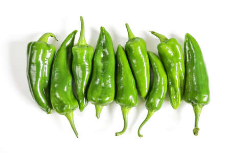 Group of raw green sweet pepper in row, close-up isolated on white backgroundの写真素材