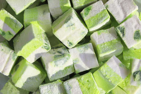 Close-up, marshmallow cubes, green kiwi fruit sweet dessert in sunlightの写真素材