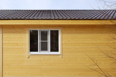 Wall of wooden house with window, texture surface with copy space