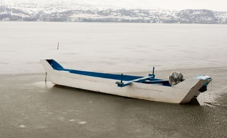 Boat in a frozen lakeの写真素材