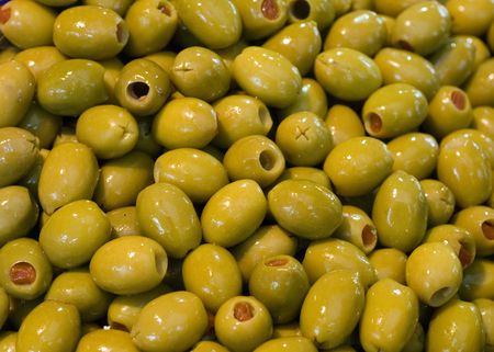 green olives at the local marketの写真素材
