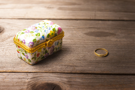 Surprise jewellery box, closed, on a wooden tableの写真素材