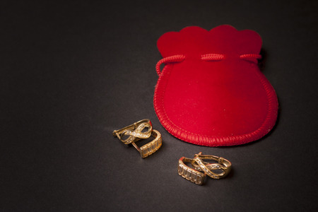 Elegant pair of earrings isolated on grey backgroundの写真素材
