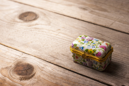 Surprise jewellery box, closed, on a wooden tableの写真素材