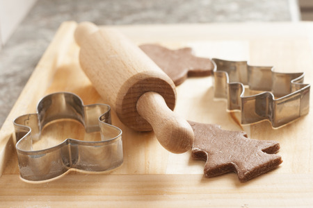 christmas gingerbread cookies baking process , dough and rolling pin,shallow depth of field.の写真素材
