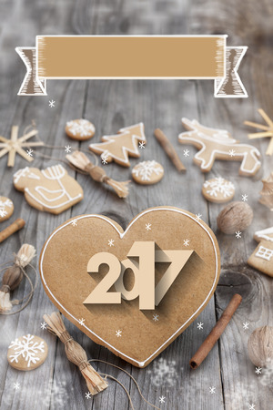 Christmas heart shaped gingerbread background. 2017 Winter holidays atmosphere. Snoflakes. Hand drawn ribbon for copy.Perfect for greeting cards, flyers, etc.Space for copyの写真素材