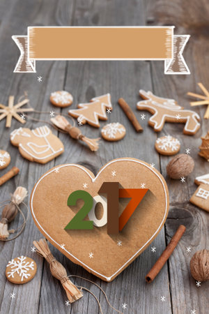 Christmas heart shaped gingerbread background. 2017 Winter holidays atmosphere. Snoflakes. Hand drawn ribbon for copy.Perfect for greeting cards, flyers, etc.Space for copyの写真素材