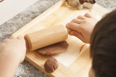 christmas gingerbread cookies baking process , dough and rolling pin,shallow depth of field.の写真素材