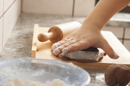 christmas gingerbread cookies baking process , dough and rolling pin,shallow depth of field.の写真素材