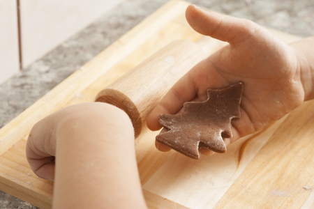christmas gingerbread cookies baking process , dough and rolling pin,shallow depth of field.の写真素材