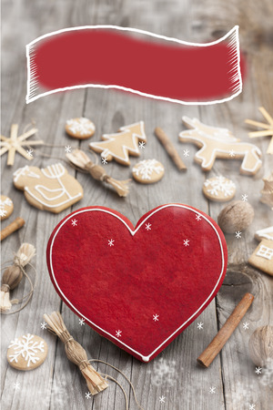 Christmas heart shaped gingerbread background. Winter holidays atmosphere. Snoflakes. Hand drawn ribbon for copy.Perfect for greeting cards, flyers, etc.Space for copyの写真素材