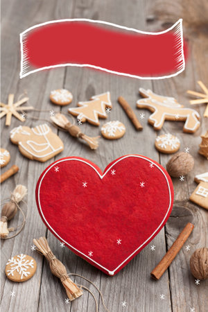 Christmas heart shaped gingerbread background. Winter holidays atmosphere. Snoflakes. Hand drawn ribbon for copy.Perfect for greeting cards, flyers, etc.Space for copyの写真素材