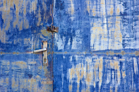 blue metal door with old handle in grungy style closeup . の写真素材