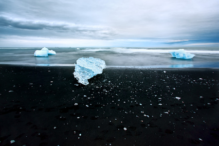 Ice on a black beachの写真素材