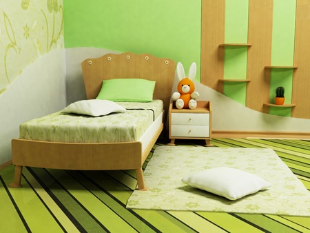 A nice green room for children with a sofa, shelves and a tableの写真素材