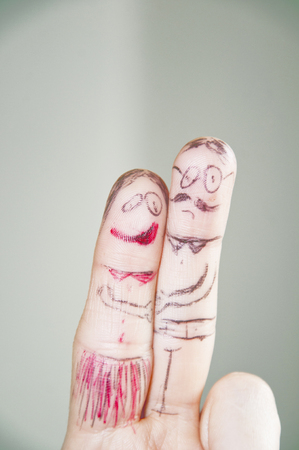 Funny drawings on the hand's fingersの写真素材