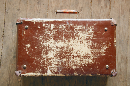 brown suitcase on the wooden floorの写真素材