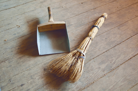 Scoop and broom on the floorの写真素材