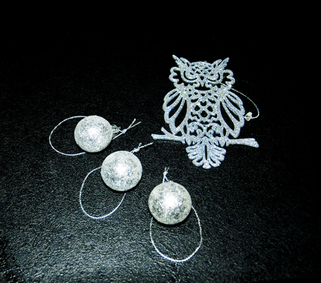 New Year's toys on a black background, an owl and ballsの写真素材