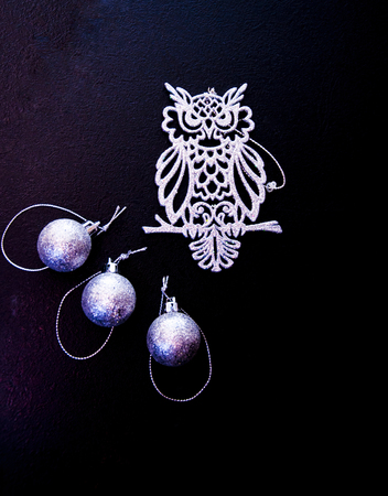 New Year's toys on a black background, an owl and ballsの写真素材