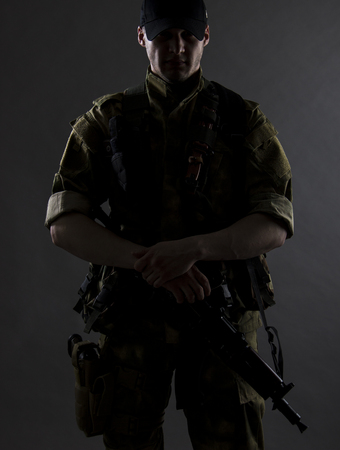 A military portrait. The military man is standing with gun.の写真素材