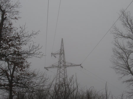 Power transmission tower in the fog outside the cityの写真素材