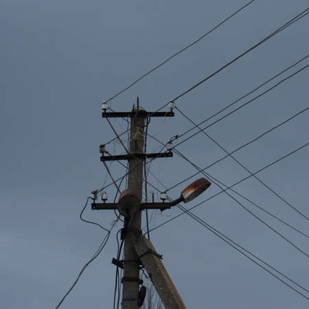 Power line against gray skyの写真素材