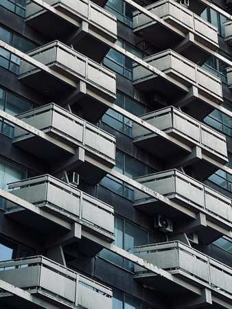 A Detailed View of Modern Apartment Building with Repetitive Balconies and Sleek Architectural Design Elements