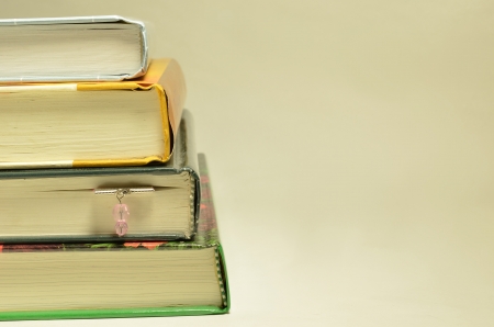 Stack of four books and one bookmarkの写真素材