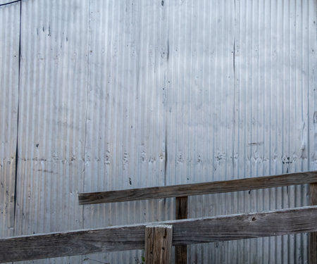 Textured Silver Metal Wall with Wood Railingの写真素材