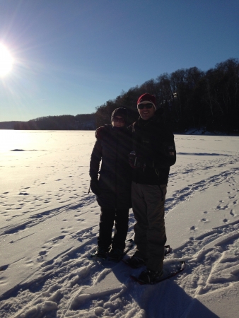 Couple posing on a snow covered lake while snowshoeing の素材