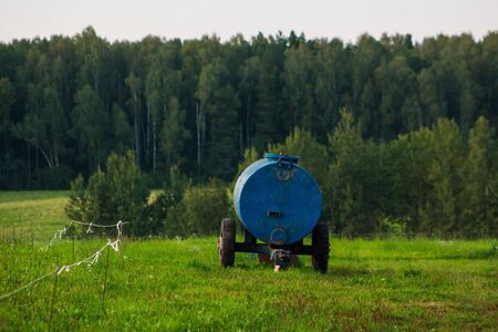 Blue can with milk in the fieldの写真素材