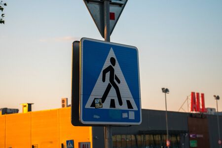 Pedestrian crossing sign at sunsetの写真素材