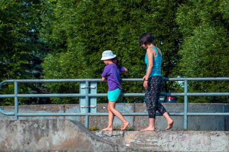 Woman with girl running in the parkのeditorial素材