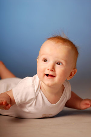 A smiling little boy on a floor
