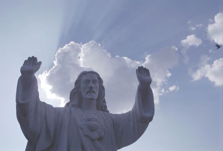 Statue on young man against skyの写真素材