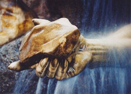 A hand of statue holding a stoneの写真素材