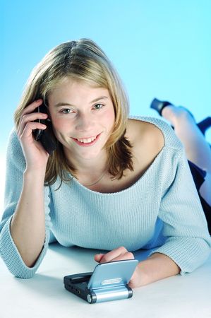 An young pretty sexy blonde girl with cellphoneの写真素材