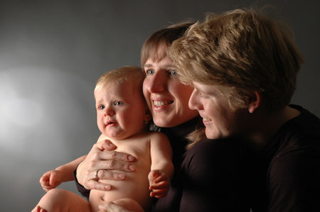 A happy young couple with their child