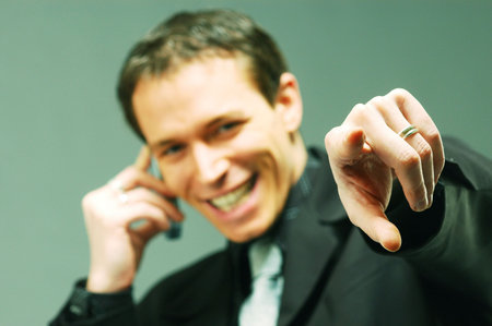 A young pointing man in suitの写真素材