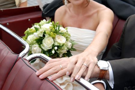 Hands of young newlyweds holding each otherの写真素材