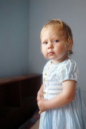 A little blonde girl in white clothesの写真素材